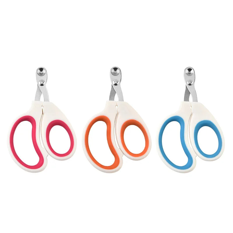 Three pairs of pet nail clippers with colorful handles on a white background